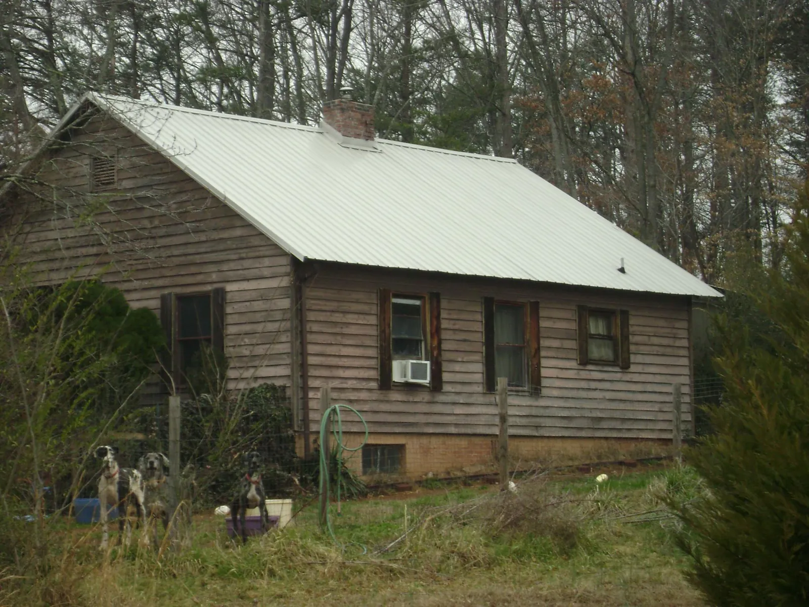 White metal roof on an old wood sided farmhouse, from a Metal Roof Installation job in Chancellor